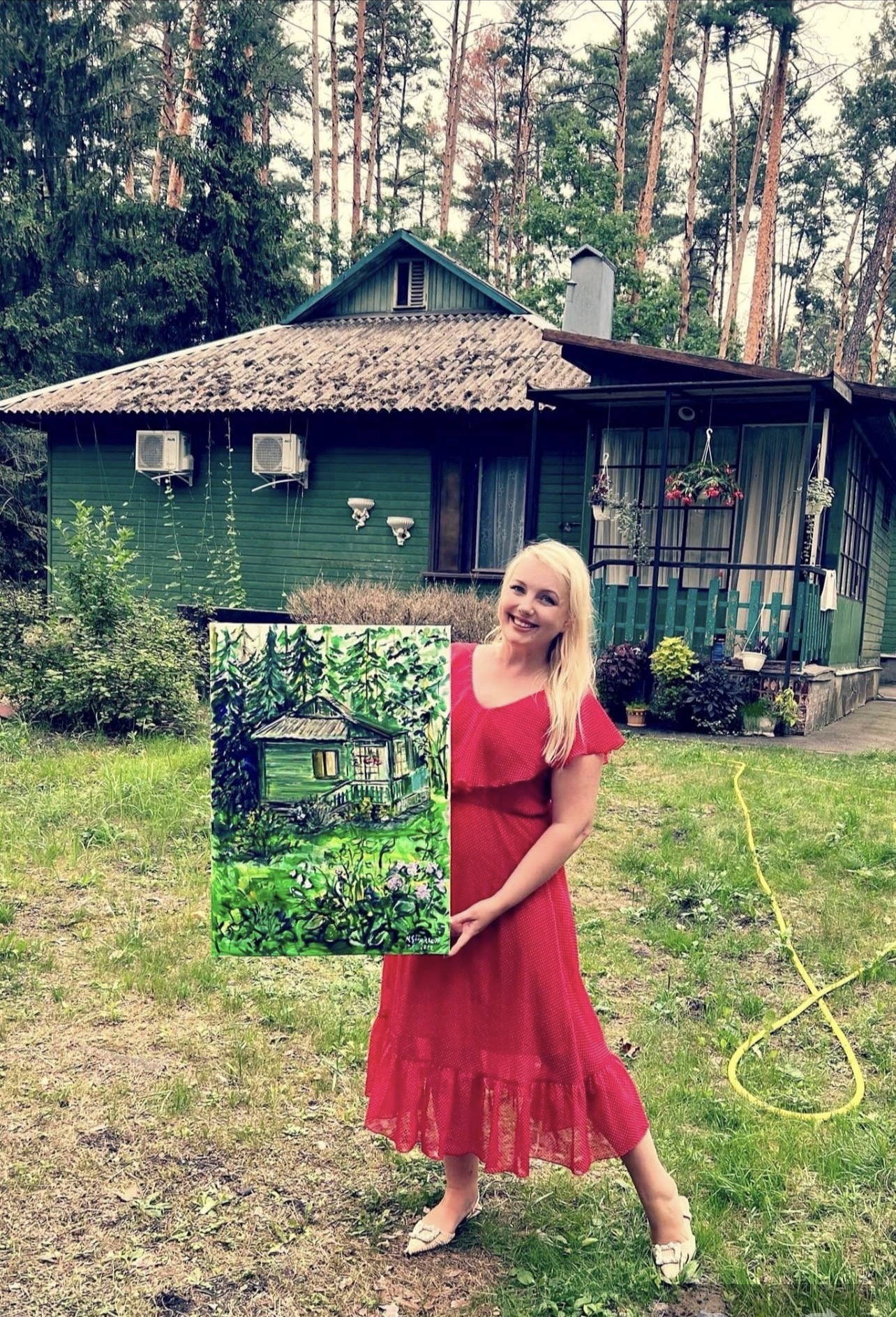 Ukrainian artist Marina Stognieva with the painting Country House and Garden